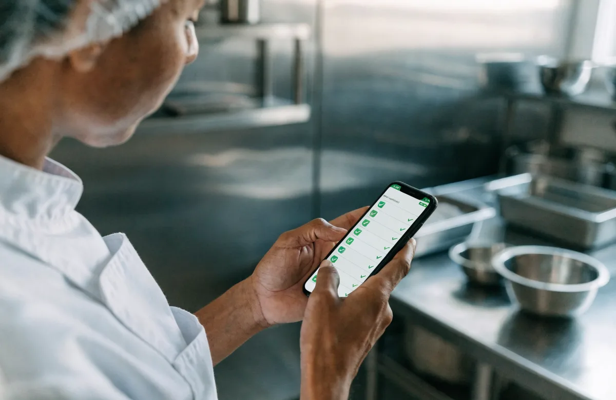 Food-safety and hygiene checklist run on the phone in a kitchen