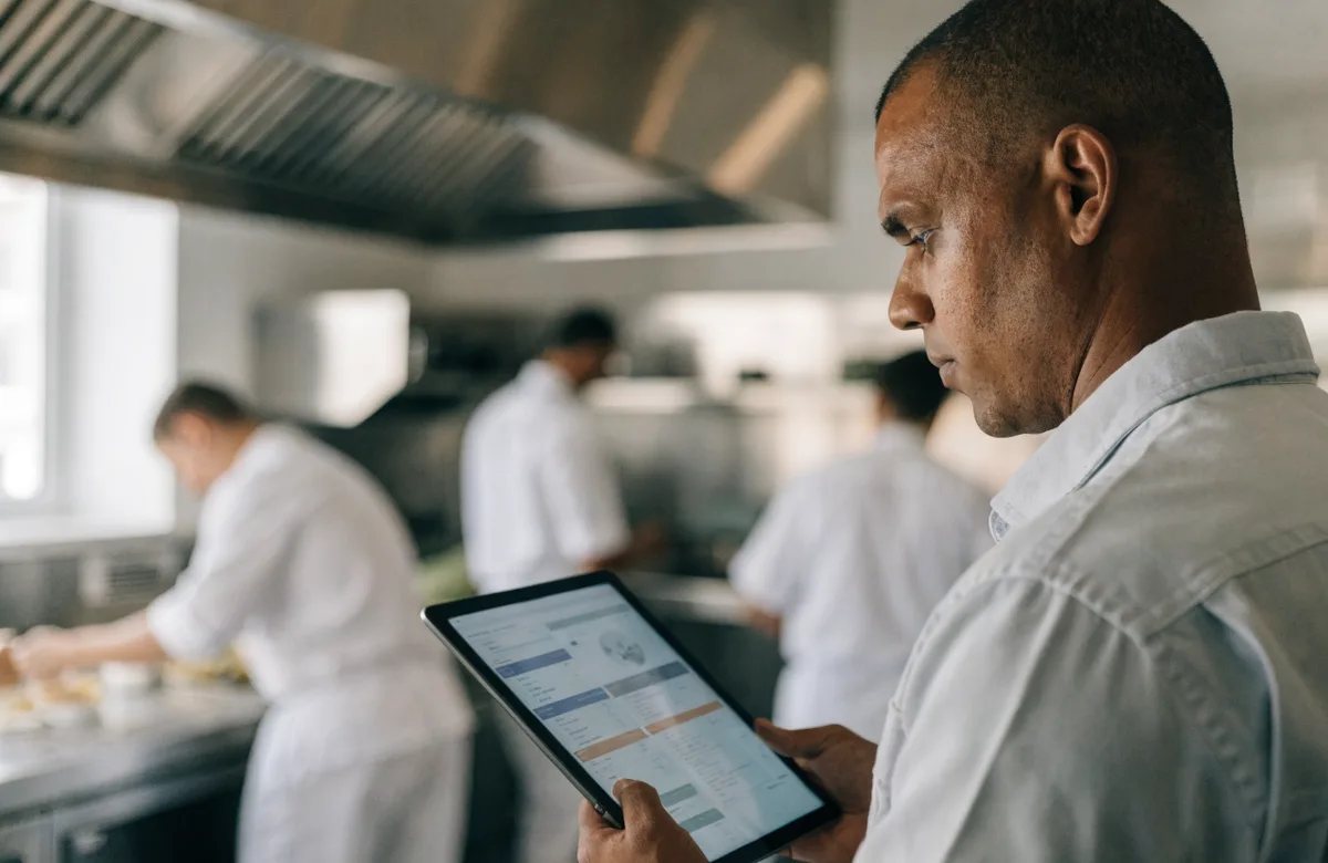 Operations manager reviewing the multi-site dashboard on a tablet